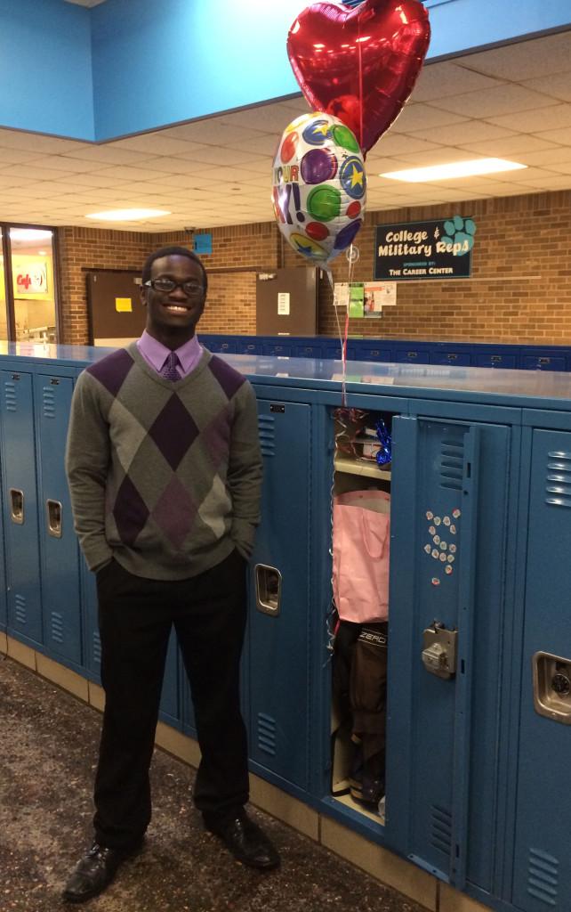 Rodney Williams, senior, posing with locker and balloons