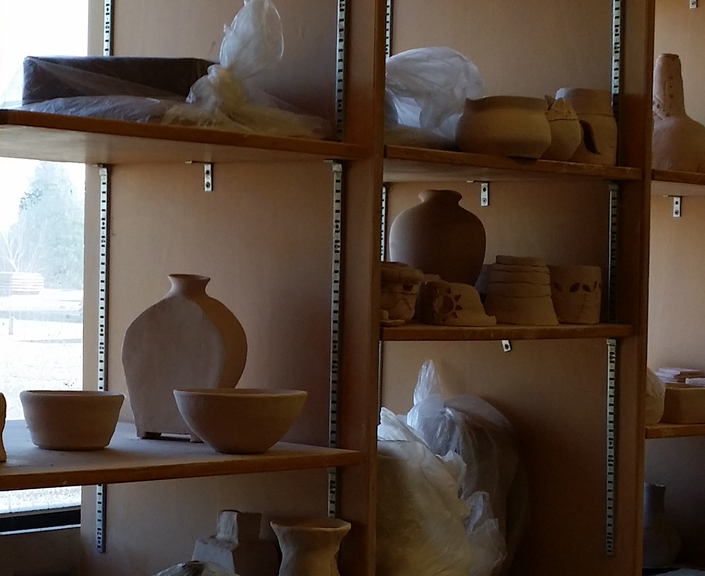 Ceramic pots on a shelf in room 237.